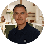 Modern man smiling in a bright, modern office environment, representing professional service at Catalyst.